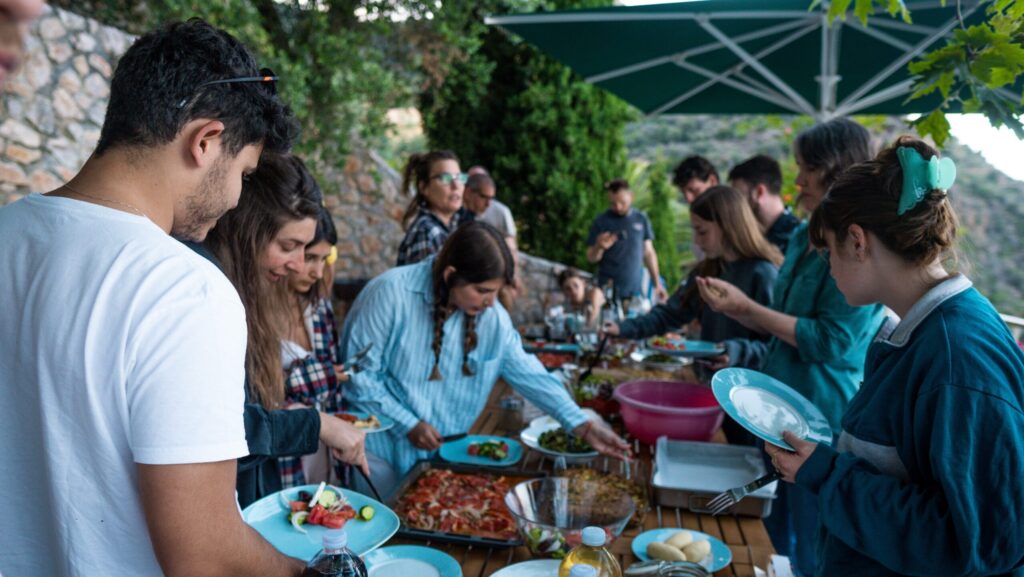 People enjoy a greek hand made meal